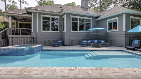 47 Kingston. a gray house with a pool