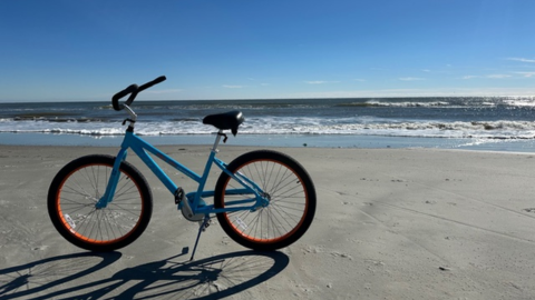 Alljoy Bike & Beach Rentals. A bike on a beach.