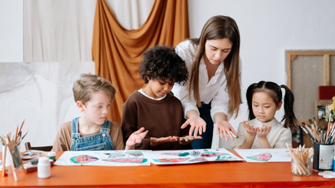 Arts Center of Coastal Carolina Summer Camps. 3 kids in what looks like an art class