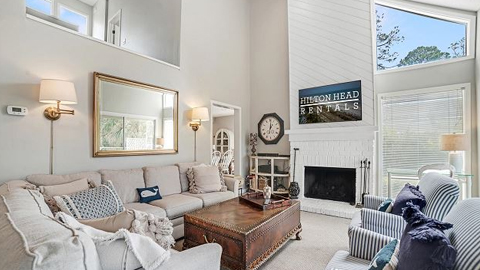 Gadwall 3. a living room with high ceilings, a fire place