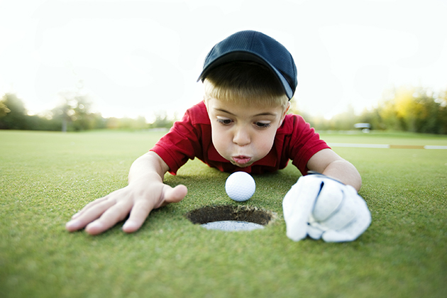 kid playing golf