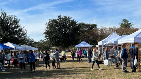 Hilton Head Community Market. tents with people walking around
