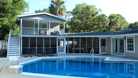 Sandy Feet Retreat a gray house with a pool