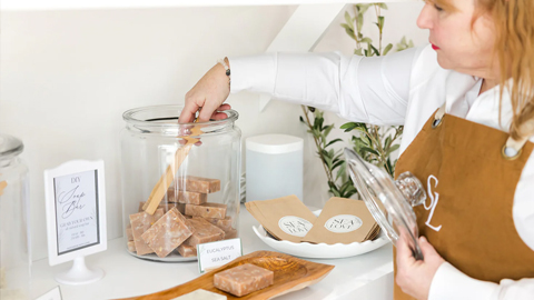 Sea Love Hilton Head. a woman grabbing something from a large jar