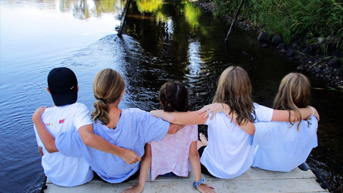 2024 Summer Camps on Hilton Head. Kids sitting on a dock