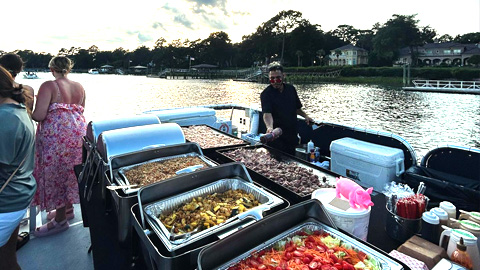 Take a Hilton Head Island Dinner Cruise. a man serving a buffet on a boat
