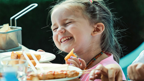 Best Kid-Friendly Restaurants on Hilton Head. a little girl smiling while eating