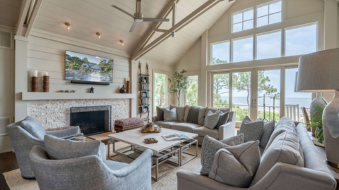 Hilton Head Exclusives. a tv room with vaulted ceilings