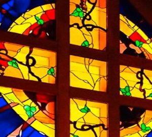 Holiday Worship. colorful stained glass cross